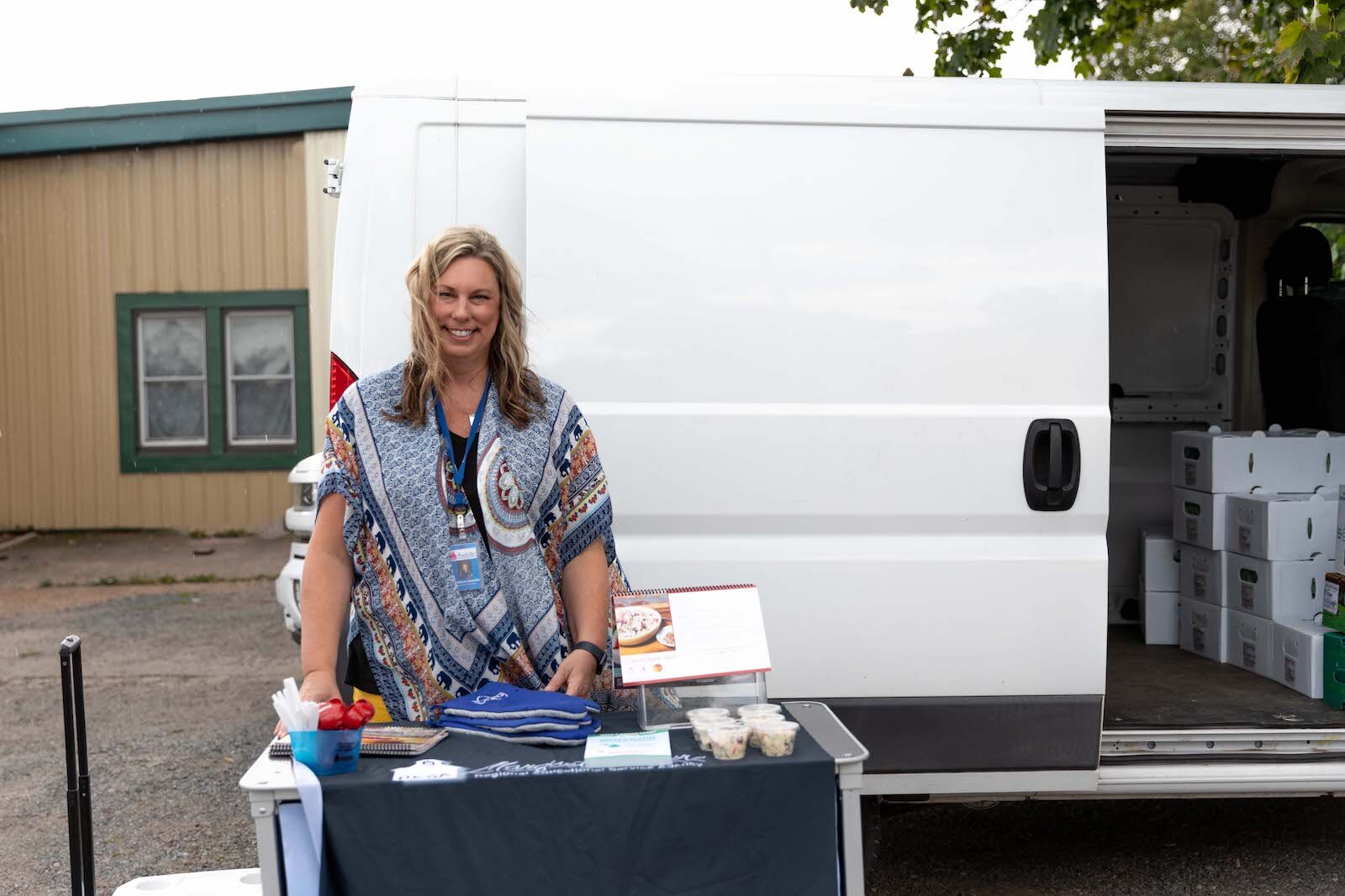 MARESA Nutrition Educator Michelle Granger at a Michigan Farm to Family: CSA pickup at Lakeshore Depot.