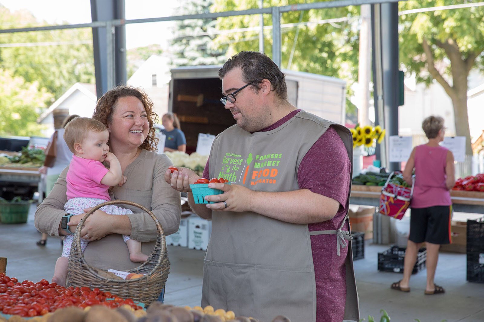 A Farmers Market Food Navigator talks to visitors.
