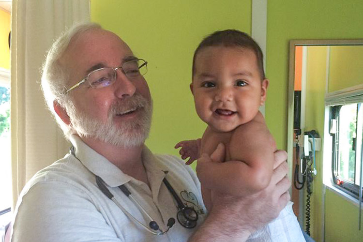 Dr. Don Bouchard with a young patient.