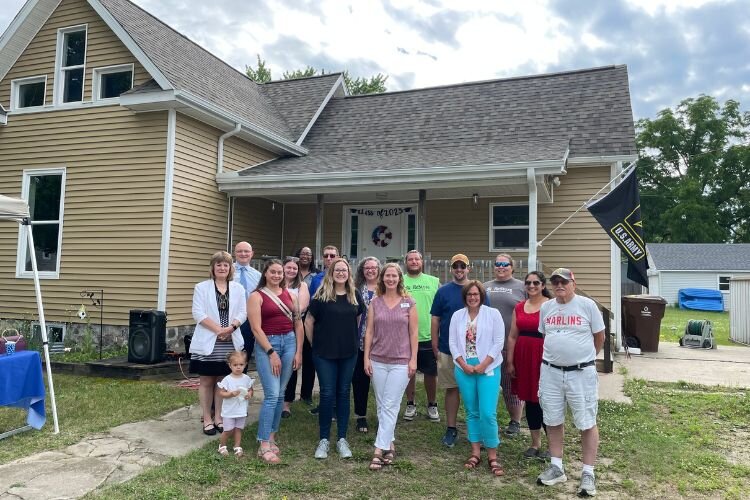 Habitat staff, volunteers, and board members, plus Custer’s friends, financial coach, and pastor, supported Custer at a special public House Blessing event.