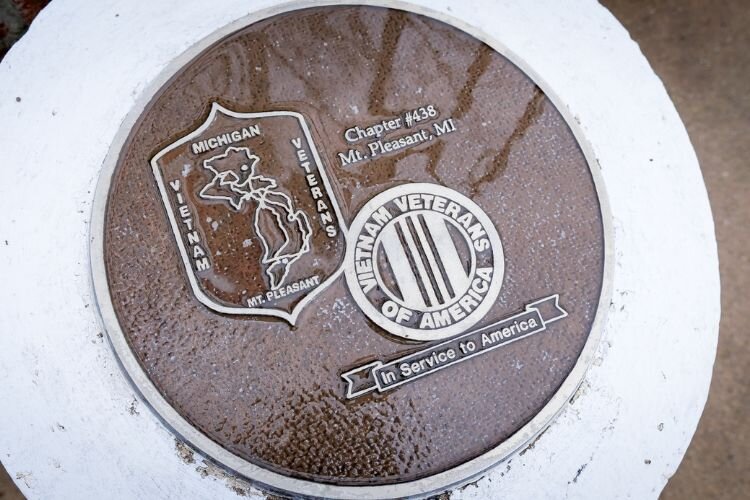 Memorial monuments and educational plaques are placed throughout the property on the northwest side of Island Park.