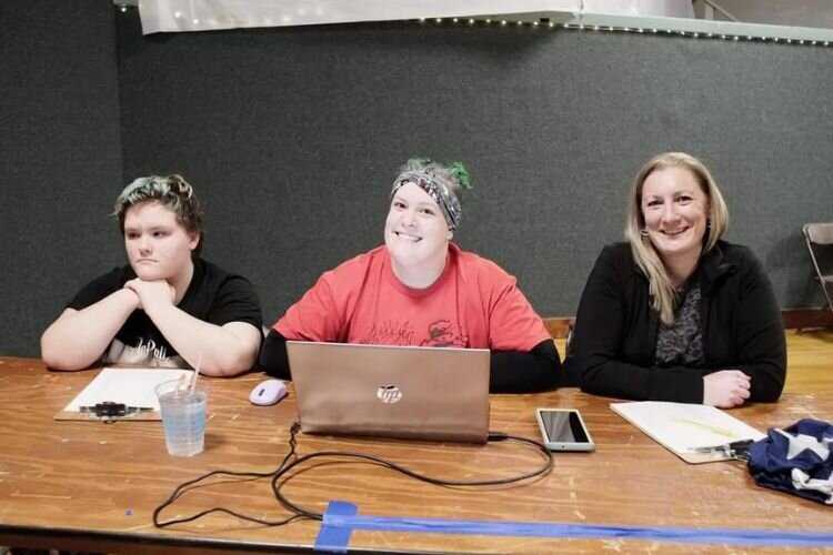 Sarah Vandemark (center) is with other Central Michigan Mayhem roller derby team members keeping score at a Bout.