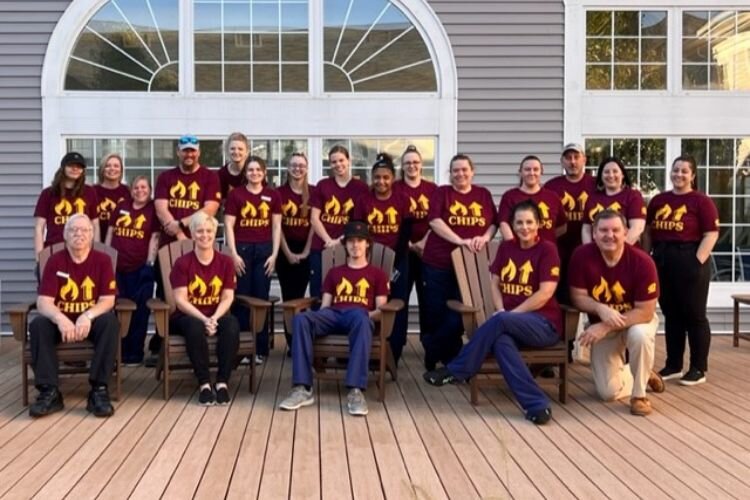 In 2022, the Comfort Inn staff wore Game Day t-shirts.