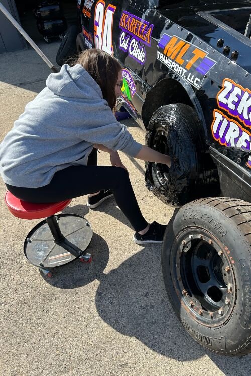 Maggie Dickman with her car at the Mt. Pleasant Speedway.