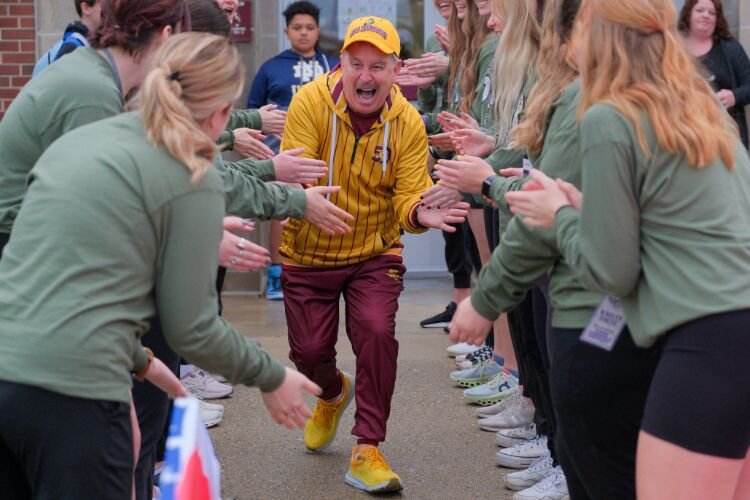 Scott McNeal, known as “Gus Macker,” runs onto the court as event staff are introduced in Mt. Pleasant, MI on Saturday, April 27, 2024.