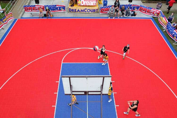 The “Dream Court” is center stage at Gus Macker, described as a “Disney-like” experience for 3-on-3 basketball. Dream Court games feature live play-by-play announcing, team introductions, and a colorful playing surface.