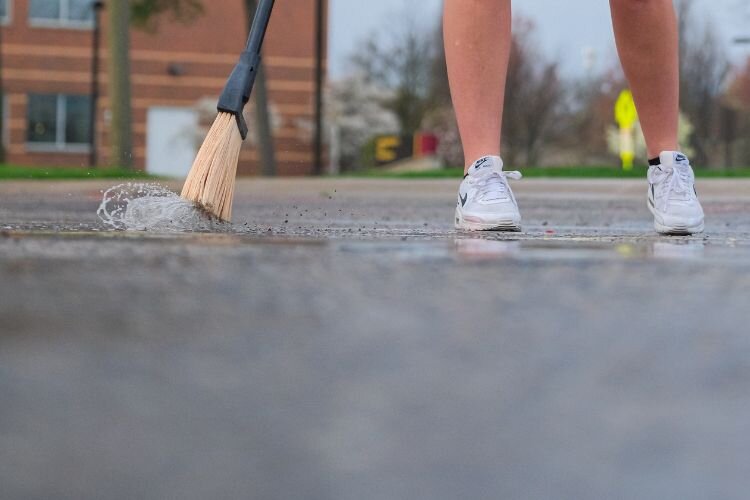 RPL 333: Production of Festivals and Events students arrive at 7 a.m. to prepare basketball courts for play following a night of heavy rain in Mt. Pleasant, MI on Saturday, April 27, 2024.