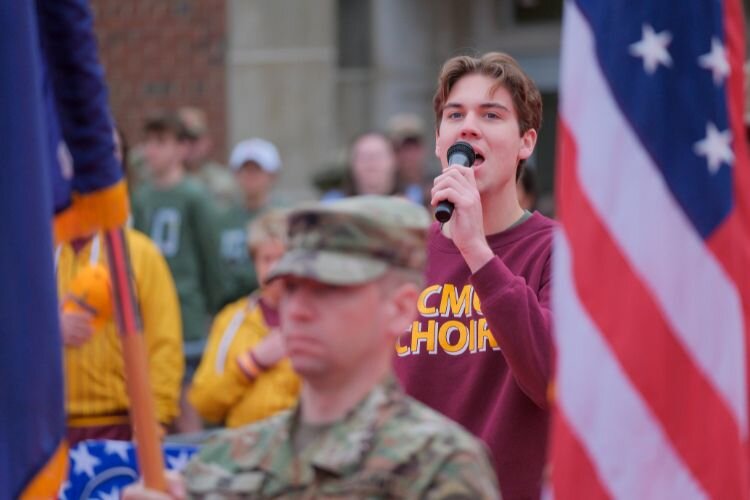 Central Michigan University student Oliver Gottbreht sings the Star Spangled Banner as the Gus Macker basketball tournament begins in Mt. Pleasant, MI on Saturday, April 27, 2024.