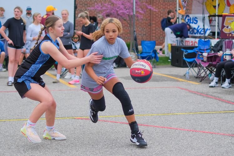 Game play in the female junior division of the Gus Macker 3-on-3 basketball tournament in Mt. Pleasant, MI on Saturday, April 27, 2024.