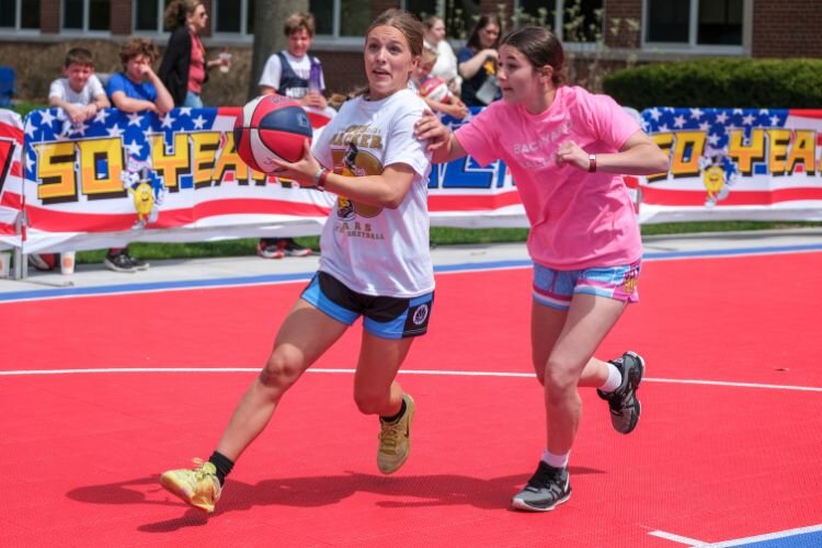 Tournament participants visit “Bracketville,” where tournament brackets are updated with games’ scores and the schedule of games. 