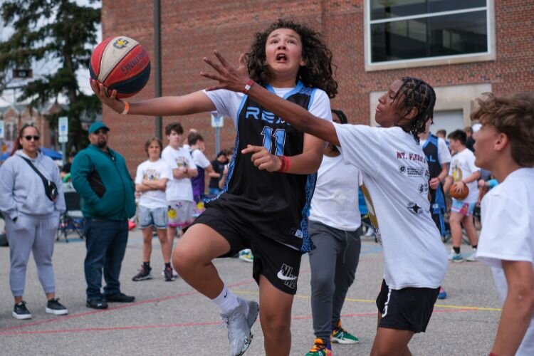 Game play in the male junior division of the Gus Macker 3-on-3 basketball tournament in Mt. Pleasant, MI on Saturday, April 27, 2024.