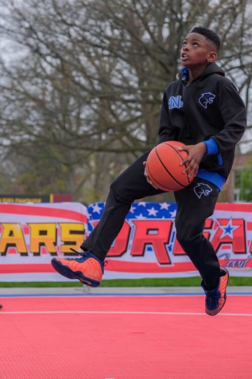 Jerome (age 10) of Saginaw, MI warms up on the Dream Court prior to the start of the Gus Macker 3-on-3 basketball tournament in Mt. Pleasant, MI on Saturday, April 27, 2024.