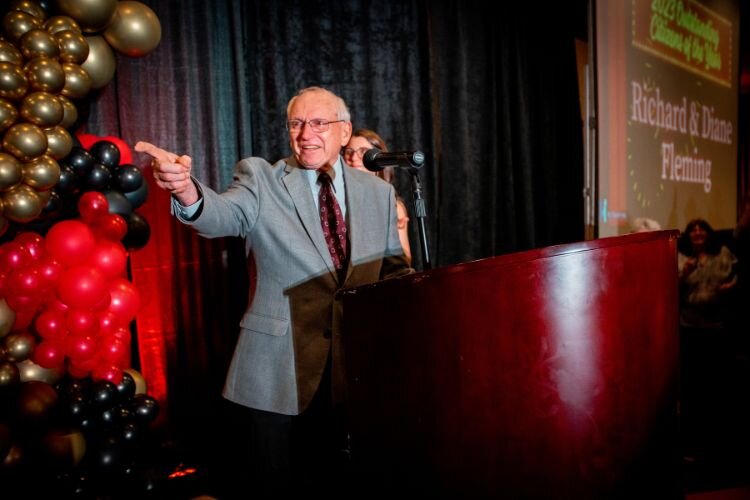 Richard Fleming makes on-stage remarks after receiving the prestigious Citizens of the Year award with his wife, Diane. Courtesy Mt. Pleasant Area Chamber of Commerce