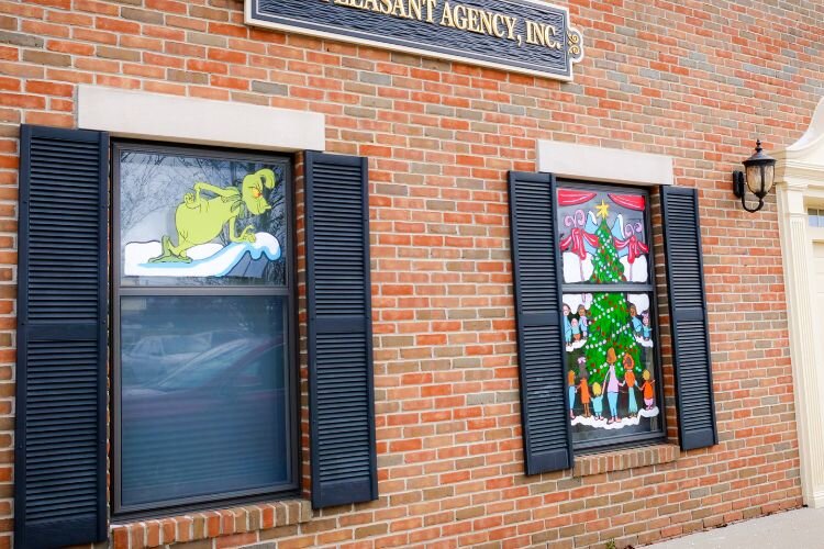 Characters from “The Grinch” grace windows of Mt. Pleasant Agency and Central Insurance painted by Corby Blem. Photo Credit: Courtney Jerome / Epicenter Mt. Pleasant