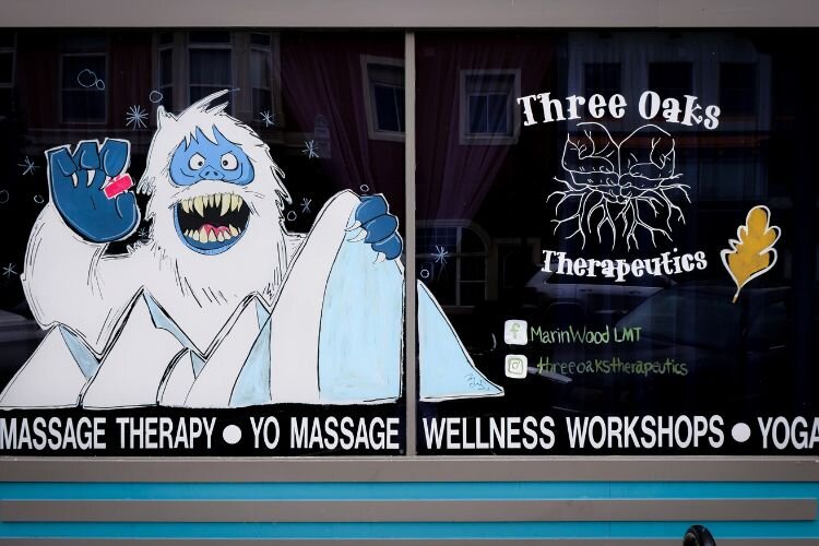 Artist Megan Bair painted a giant Yeti on the windows of Three Oaks Therapeutics in downtown Mt. Pleasant. Photo Credit: Courtney Jerome / Epicenter Mt. Pleasant