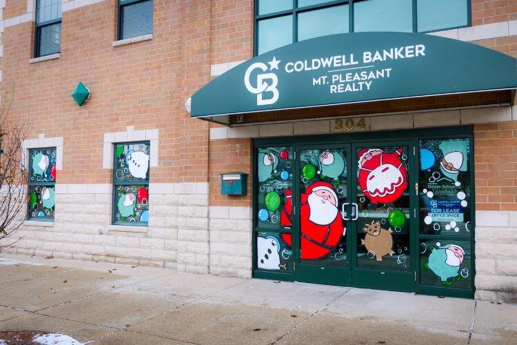 The windows of Coldwell Banker display what artist Corby Blem entitles “North Pole Fizzy Lifting Drink.” Photo Credit: Courtney Jerome / Epicenter Mt. Pleasant