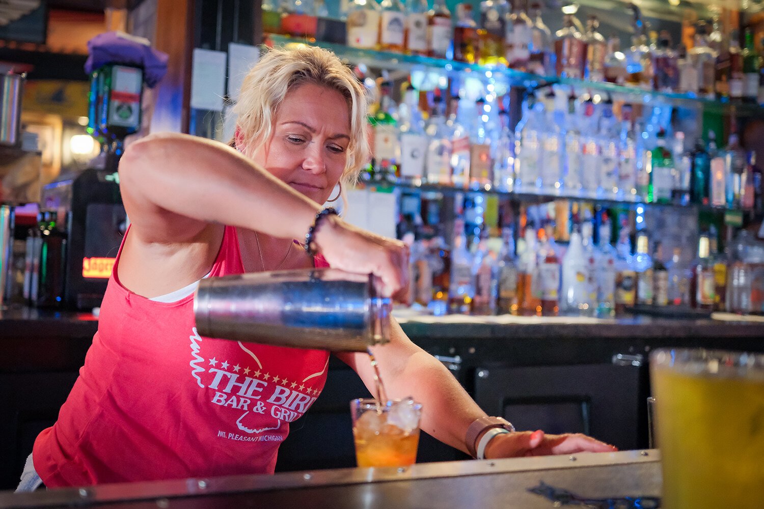Bartender Allison Curtiss pours a drink for a patron at The Bird Bar and Grill in Mt. Pleasant, MI on Saturday, July 29, 2023. (Photo: Dan Gaken/Epicenter) 