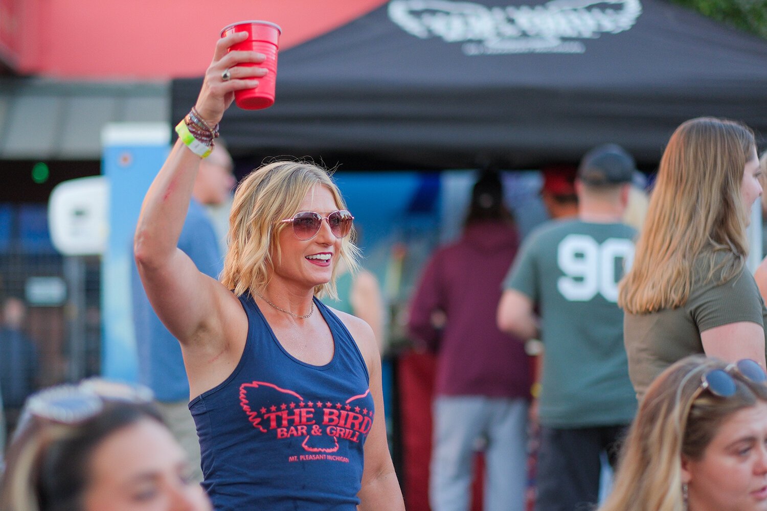 Rachel Blizzard of Mt. Pleasant dances with the crowd on Main Street in front of The Bird Bar and Grill in Mt. Pleasant, MI on Saturday, July 29, 2023. (Photo: Dan Gaken/Epicenter) 