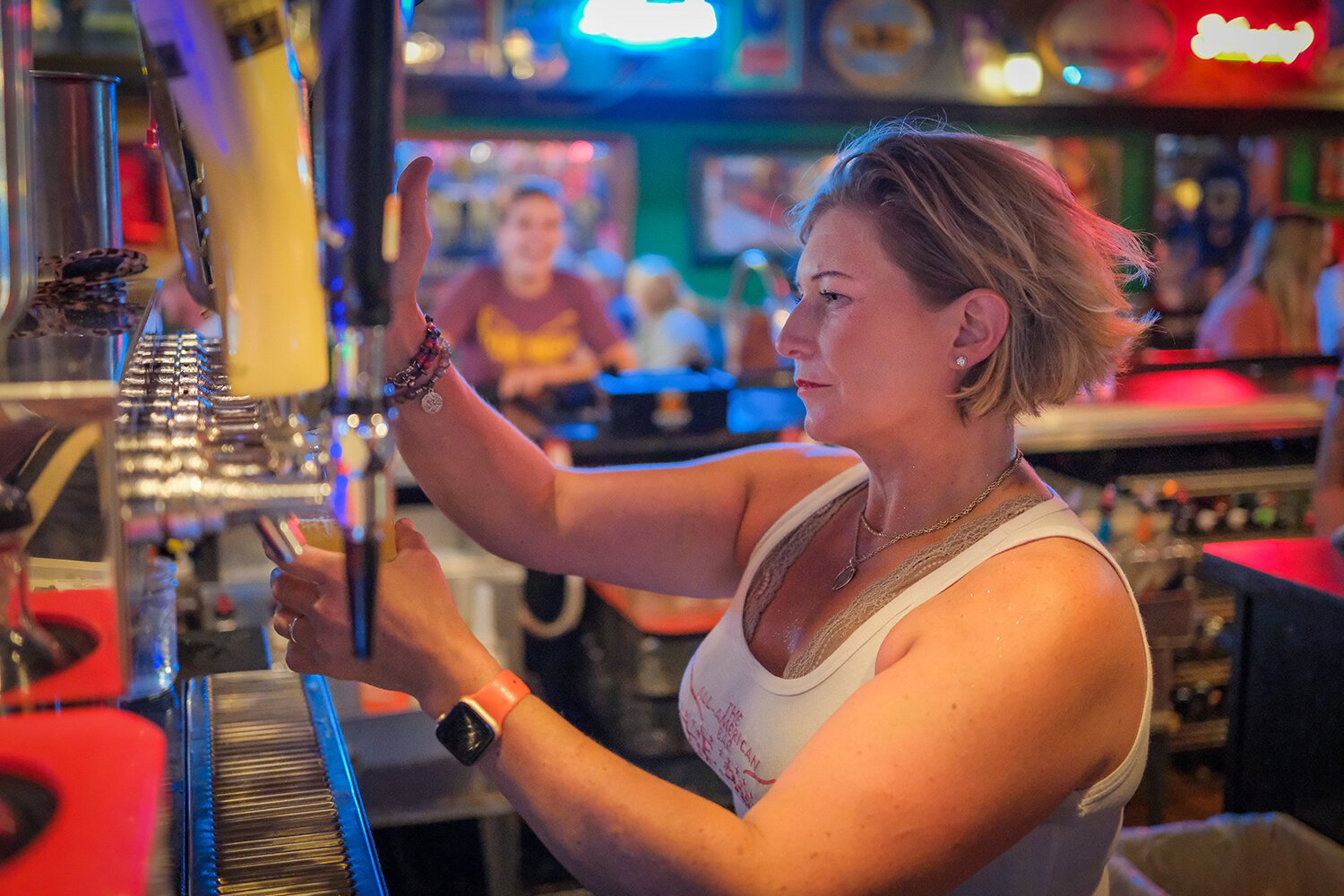 Bird Bar and Grill manager Stacy Rabish pours a drink for a customer during the anniversary party for The Bird Bar and Grill in Mt. Pleasant, MI on Saturday, July 29, 2023. (Photo: Dan Gaken/Epicenter)