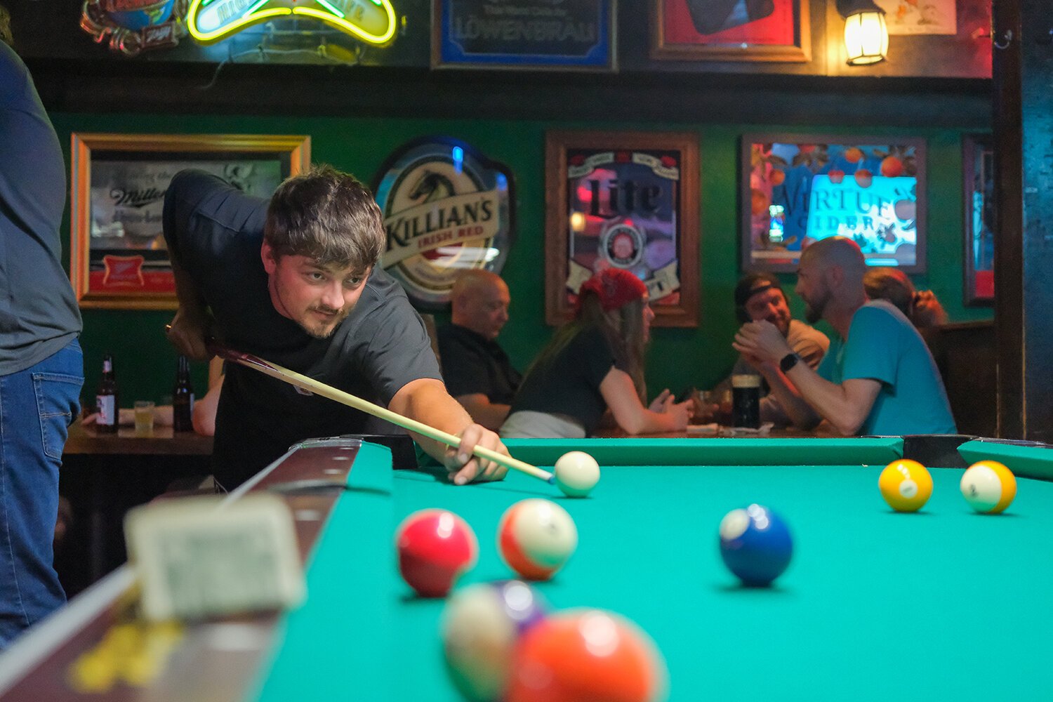 Bar patrons keep the billiards table and dart boards active throughout the 90th anniversary celebration for The Bird Bar and Grill in Mt. Pleasant, MI on Saturday, July 29, 2023. (Photo: Dan Gaken/Epicenter)