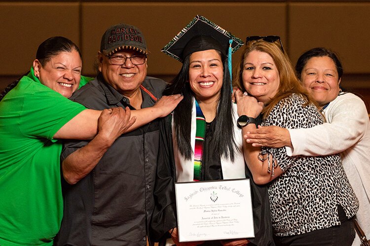 Monica Gonzalez celebrates with family after receiving an Associate of Arts in Business degree at Saginaw Chippewa Tribal College. (Photo courtesy of Dr. Mary Pelcher)