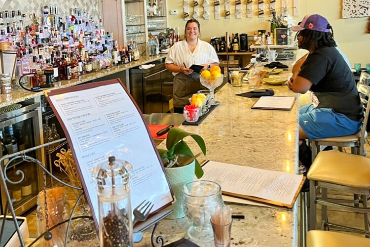 A STIR Craft Cocktails & Modern Kitchen staff member prepares to take a customer's order at the bar. (Photo courtesy of Preston J. Slominski)