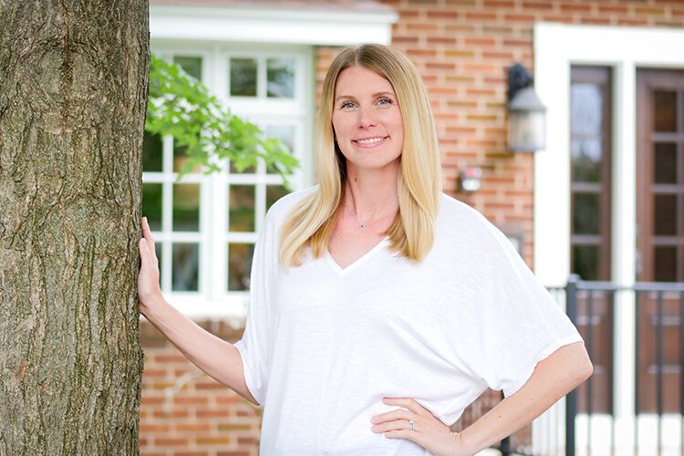 Alysha Pasquali, Mt. Pleasant Area Community Foundation (MPACF) CEO/COO, poses for a photo in front of The Hersee House at 306 S. University Ave. in downtown Mt. Pleasant. (Photo: Courtney Jerome/Epicenter)