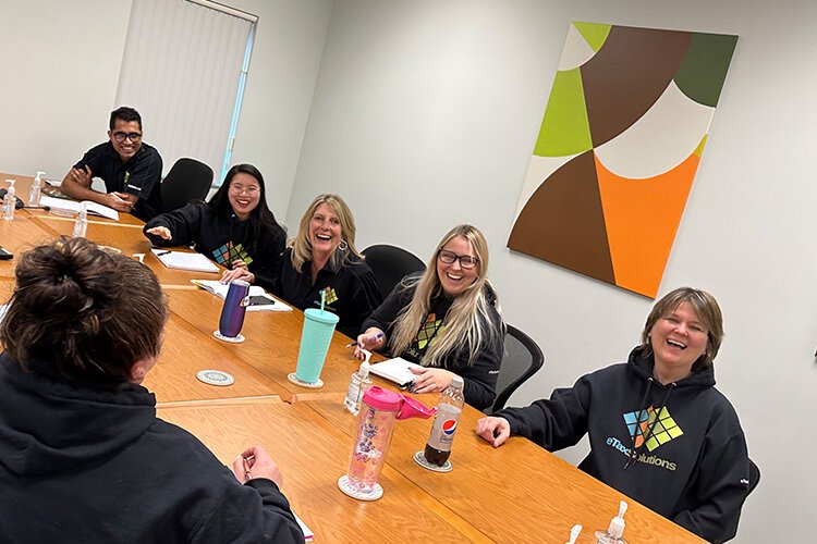 eTax Solutions team members laugh during a meeting. (Photo courtesy of eTax Solutions)