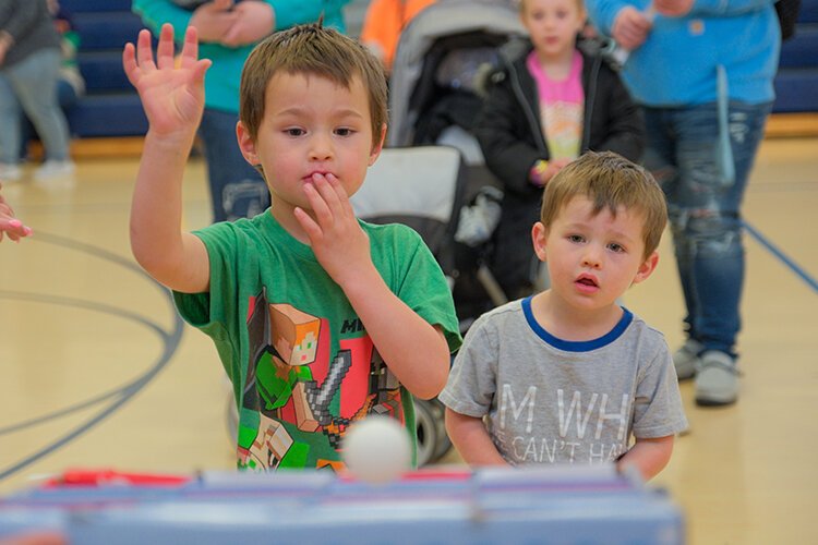 Brothers Lincoln (age 3) and Asher (age 2) of Pinkney, MI play games at Maple Syrup Festival’s Children’s Village in the Shepherd Elementary Gym in Shepherd, MI on Saturday, April 29, 2023. (Photo: Dan Gaken/Epicenter)