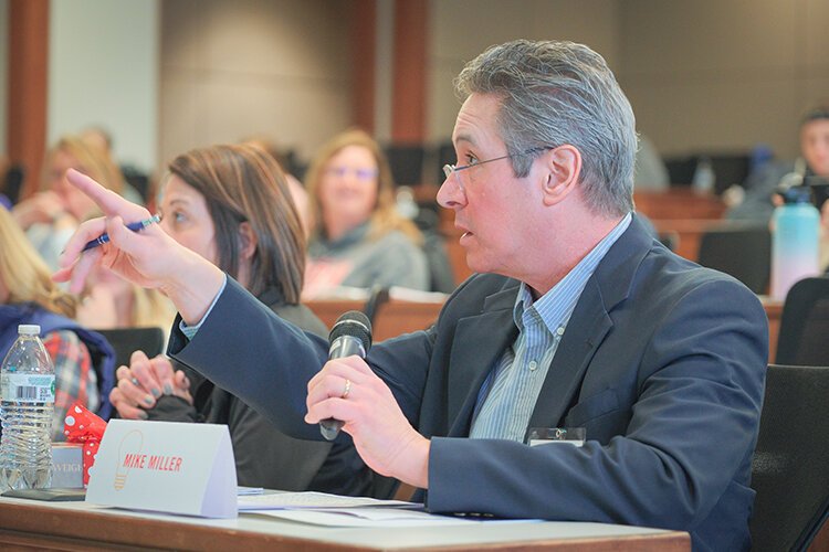 Commercial Bank Vice President Mike Miller asks students for additional details about their PITCH-ER THIS! project plans. (Photo: Dan Gaken/Epicenter)
