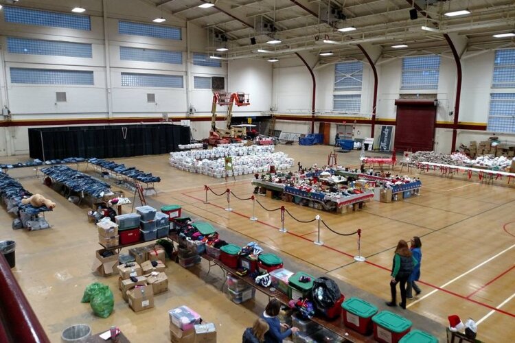 During the annual event, people move through different departments collecting coats, linens, and other household goods. (Photo courtesy of Christmas Outreach of Isabella County)