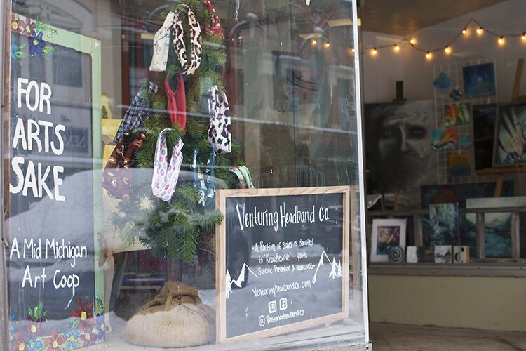 While the building's interior is undergoing renovations, the art co-op uses the window display to showcase artwork from a new local artist each month that is available for purchase online.