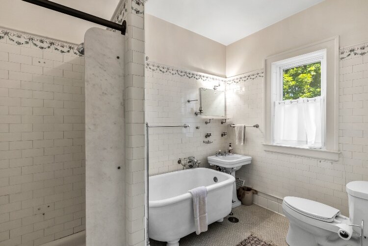 The home – built from hollow terra cotta bricks covered in a brick veneer and cypress half timbering – includes five full bathrooms and three half bathrooms.