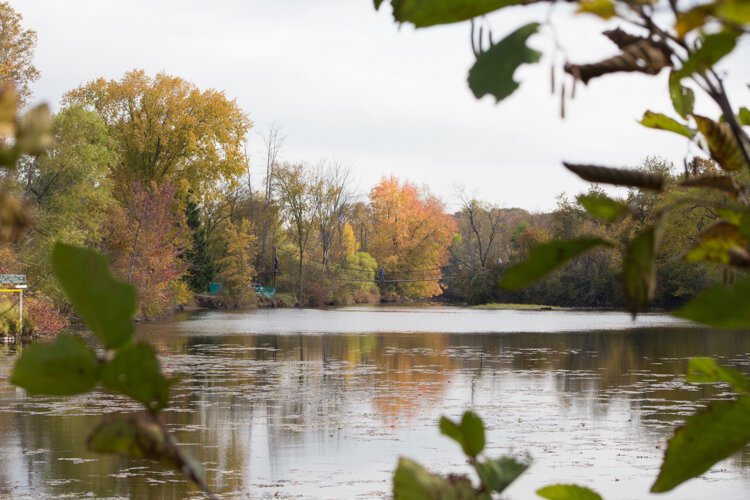 Park visitors cross a suspended bridge at Deerfield Nature Park, located on Remus Road in Mt. Pleasant, Michigan.