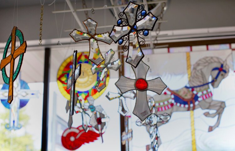 Many crosses made from stained glass can be found hanging throughout the store.

"I depend on my faith a lot to get through those slow days where I go, 'Am I going to be able to pay the bills this month?'," says Holland.