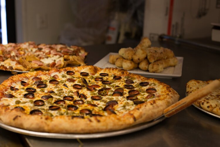 Vin Trofeo's menu offers something for everyone ranging from pizza, chicken wings, zoodles, and even soup and salads.

“Our pizza is not just the everyday pizza,” says Baird. “When we first announced that we were going to be coming to town, we got so much flak…there were two other pizza places that announced at the same time, and I think it was a bit overwhelming for the whole town, ‘Oh my gosh, not three more pizza joints seriously.’”