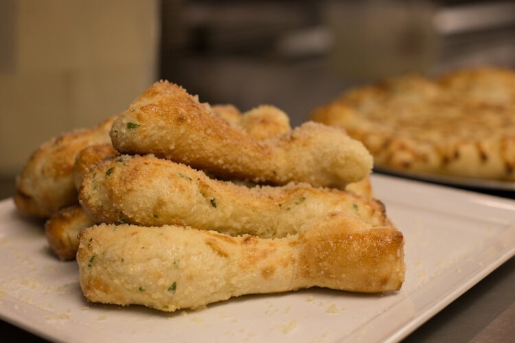 Vin Trofeo's breadsticks are made from scratch then brushed with garlic butter and sprinkled with parmesan cheese.