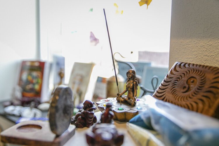An incense stand sits among spiritual trinkets at All Things Divine.