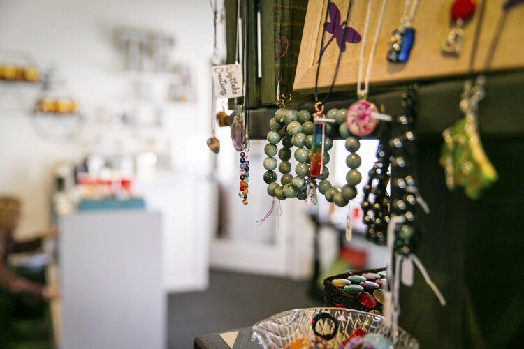 Homemade bracelets, earrings, necklaces, and other items sit around the shop at All Things Divine.