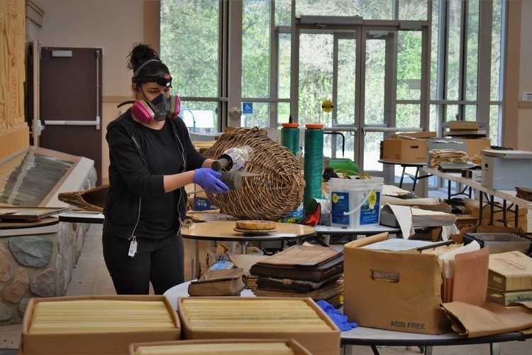 A volunteer sorts materials in the lobby.