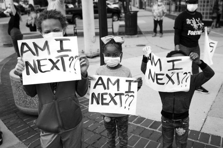 Children carried signs questioning their personal safety. Photo credit: Phil Eich, Full Steam Social Media