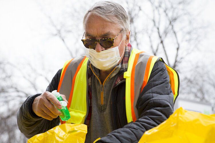 A volunteer puts items into The Care Store's emergency hygiene kits at the William and Janet Strickler Nonprofit Center.