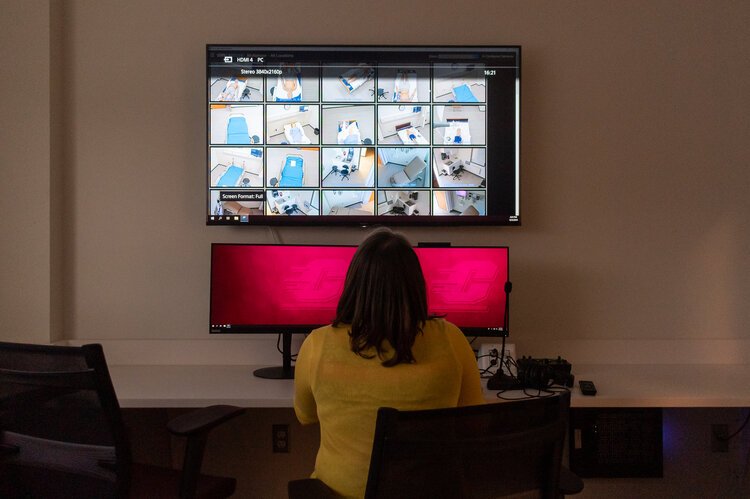 Amy Malheim demonstrates how faculty will be able to monitor and record standardized patient encounters via video and audio feeds located in each of the center’s eight standardized patient rooms in the IPEP Center. 