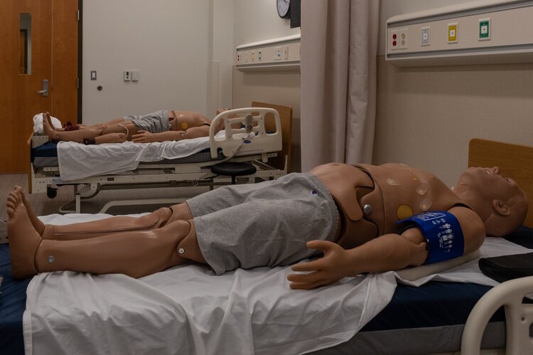A trauma mannequin and an average male mannequin share a room in the IPEP Center. 