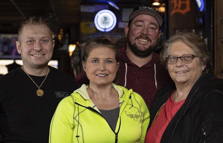 (Left to right) Managers Ben Breidenstein,Stacy Rabish, DJ Blizzard, and owner Lois Breidenstein stand in their family’s bar at The Bird Bar and Grill.