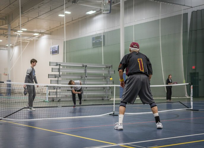 A member of the Mount Pleasant Pickleball Group tenses in preparation as his opponent hits the ball at Morey Courts.