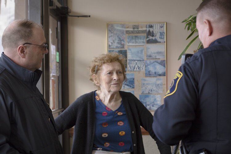 Owner of Robaire Bakery & Doughnut Shop, Dina Desormes, talks to members of the Central Michigan University Police Department (CMUPD) prior to Coffee with a Cop. 