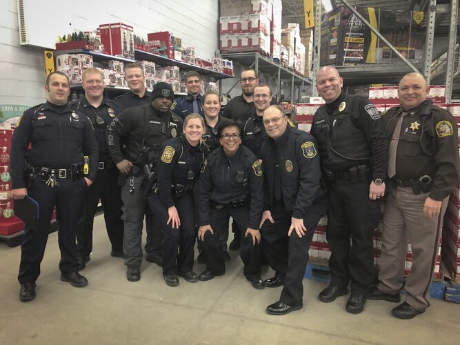 Many local law enforcement agencies participate in community events such as Coffee with a Cop, Shop with a Cop, or National Night Out. Here, law enforcement personnel are shown during the 2019 Shop with a Cop event.