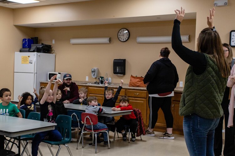 Event and Marketing Director Ericka Pauly explains the importance of having "walking shoes" on to Alma College Head Start Program preschoolers as she talks about safety at the Mount Pleasant Discovery Museum.