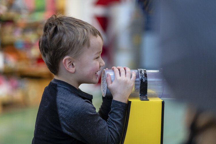 An Alma College Head Start Program preschooler interacts with the "Honey Money Bank" at the Mount Pleasant Discovery Museum. The exhibit aims to help children with their math skills.